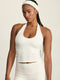 ADEL'S WORLD FABRIC: CLOUD+ MADE FOR EVERYDAY WEAR גופיית קולר מיועדת לאימונים וליום-יום. גב פתוח. הגופייה בשילוב ריפוד נשלף ושכבה פנימית. גוון לבן.