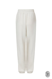 The Touch Club.מכנסיים מבד סקובה בגזרה נוחה עם סיומת גומי.כוללים כיסים צדדיים וגומי במותן עם שרוך להתאמה אישית. המכנס מבד סקובה נעים  במיוחד, מתאימים לשימוש יומיומי.מאפיינים:סיומת גומי בקרסול.כיסים צדדים.גומי במותן עם שרוך חיצוני נשלף.גוון קרם / וניל.