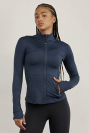 ג׳קט רוכסן מלא בגוון כחול, בגזרה הדוקה יותר, שילוב של כיסים פרונלטיים, ומקום לאגודל.