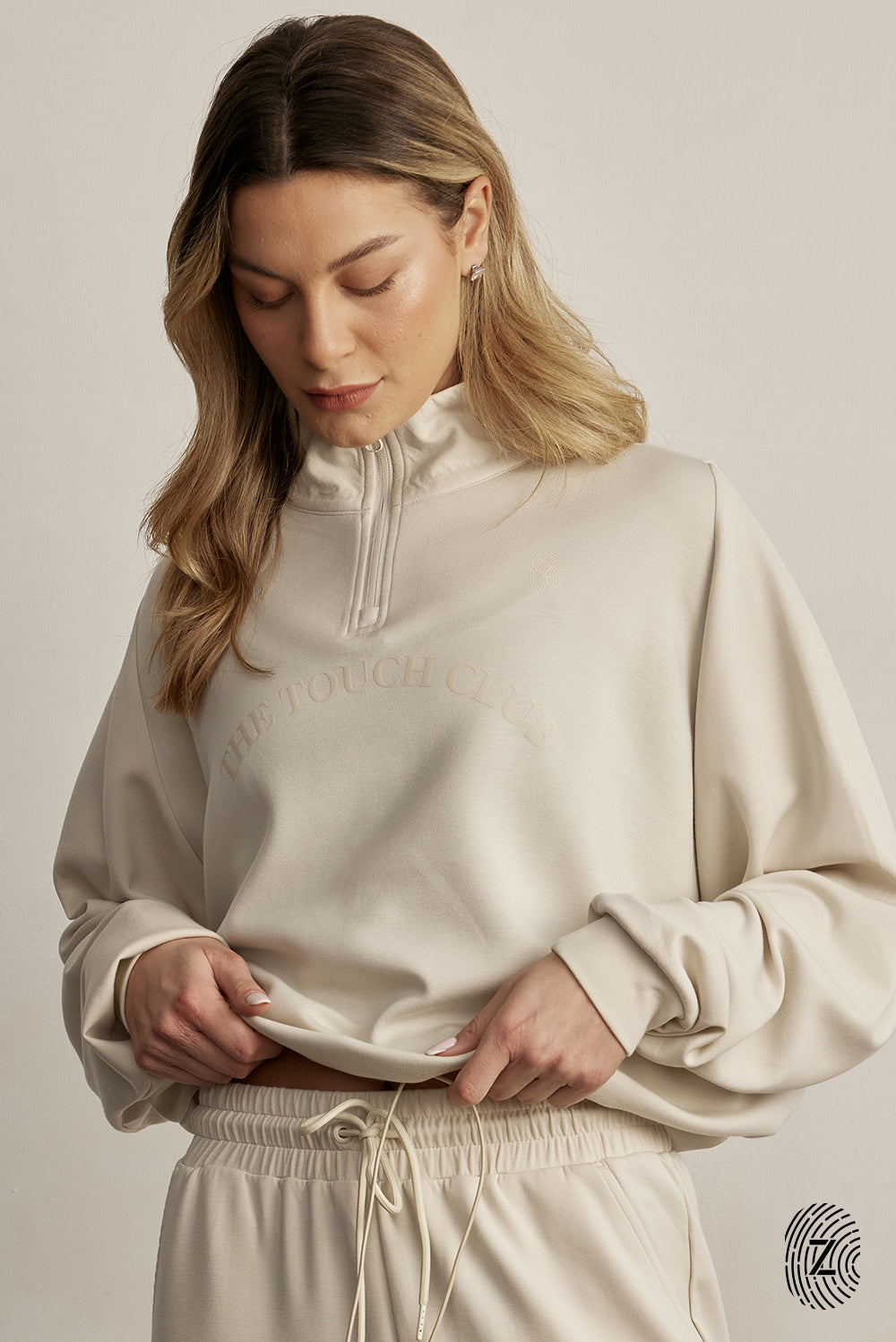 ג'קט חצי רוכסן מבד סקובה. הכירי את הג'קט המושלם למראה ספורטיבי ומעודכן. עשוי מבד סקובה איכותי ואלסטי, תחושת נוחות שאין לה תחליף. הג'קט בעל עיצוב חצי רוכסן, אידיאלי לשימוש ביום-יום.מאפיינים:עשוי מבד סקובה איכותי ומפנק.חצי רוכסן למראה ייחודי ונוח.מתאים לשימוש יומיומי או ספורטיבי.לוגו THE TOUCH CLUB לרוחב הפריט, עם טביעת האצבע.שרוך עם כפתור בחלק החיצוני של הג׳קט -  לצורך הצרת הג׳קט.גוון קרם / וניל.