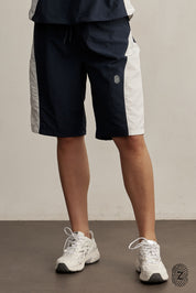 The TOUCH club.ברמודת ניילון - בשילוב של 2 גוונים - כחול ולבן/קרם.ברמודת מבד ניילון - גוון עיקרי כחול ושילוב של גוון לבן/קרם. גומי במותן ושרוכים נשלפים, לוגו TOUCH בטביעת אצבע עם מחזיר אור. מאפיינים:בד ניילון - קל ונעים למגע.בגוון כחול ושילוב לבן / קרם.בגלל שילוב הצבעים - יש לכבס בנפרד ובתוכנית עדינה וקצרה. לוגו TOUCH - מחזיר אור.גומי במותן עם שרוכים נשלפים להידוק.